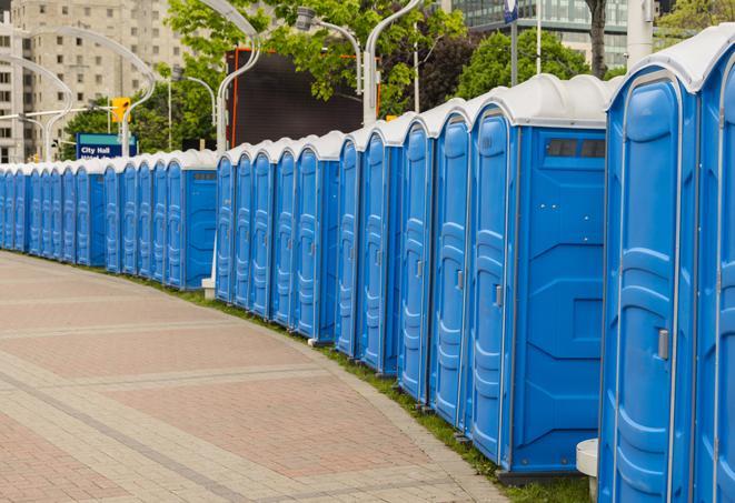 portable restrooms stationed outside of a high-profile event, with attendants available for assistance in Atoka